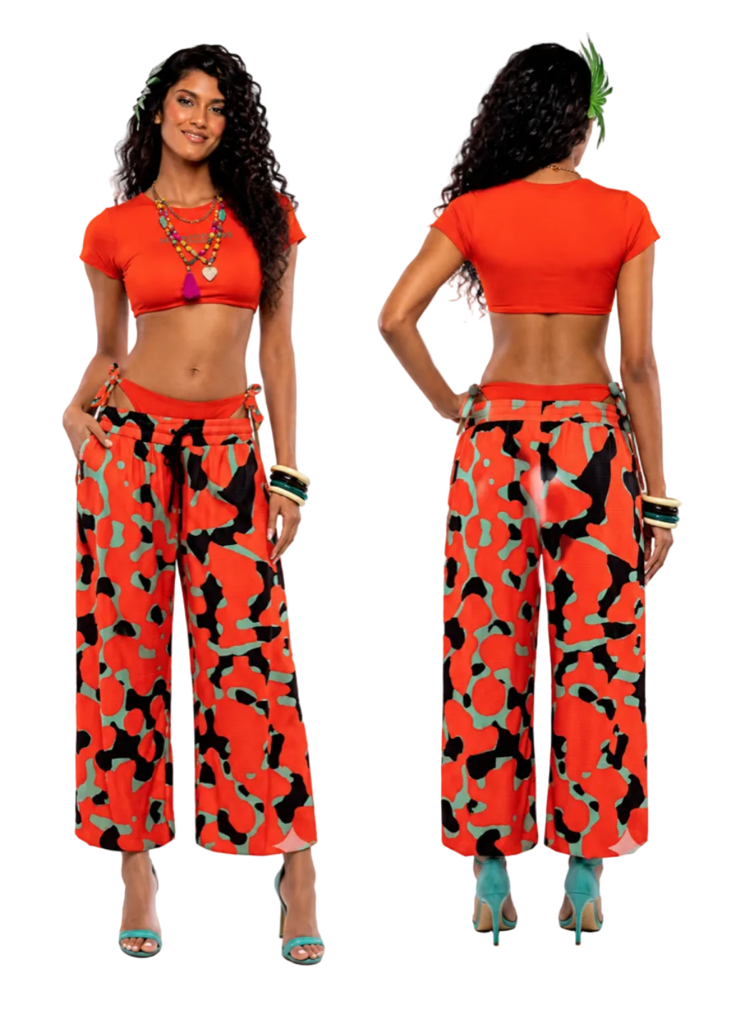 A model shown from the front and back wearing a bright orange-red crop top and matching wide-leg pants with a black and green abstract pattern, against a plain white background.