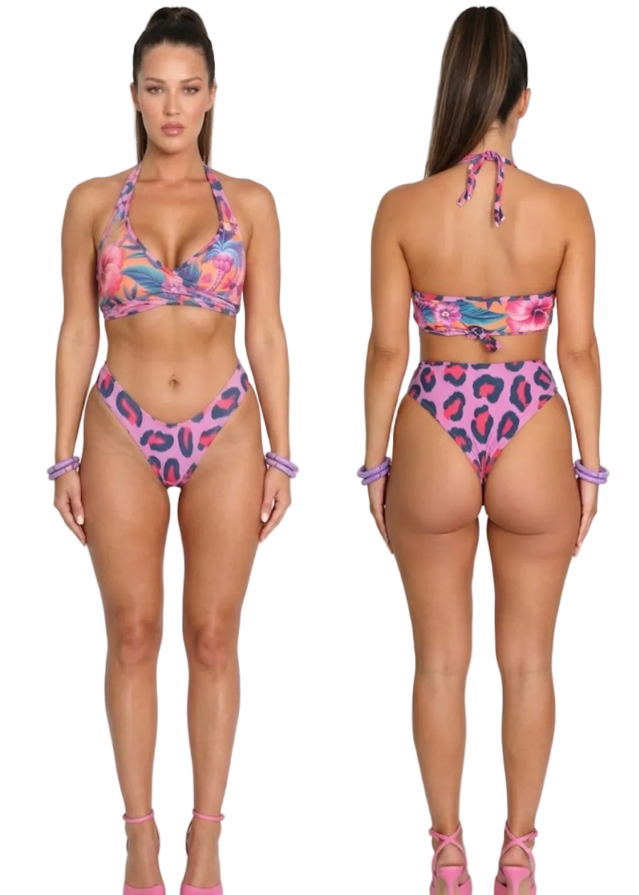 A woman modeling a two-piece bikini set shown from the front and back against a plain light gray studio background. The bikini has a bright pink base with a multicolor floral and leopard-print pattern in purple, blue, and orange.