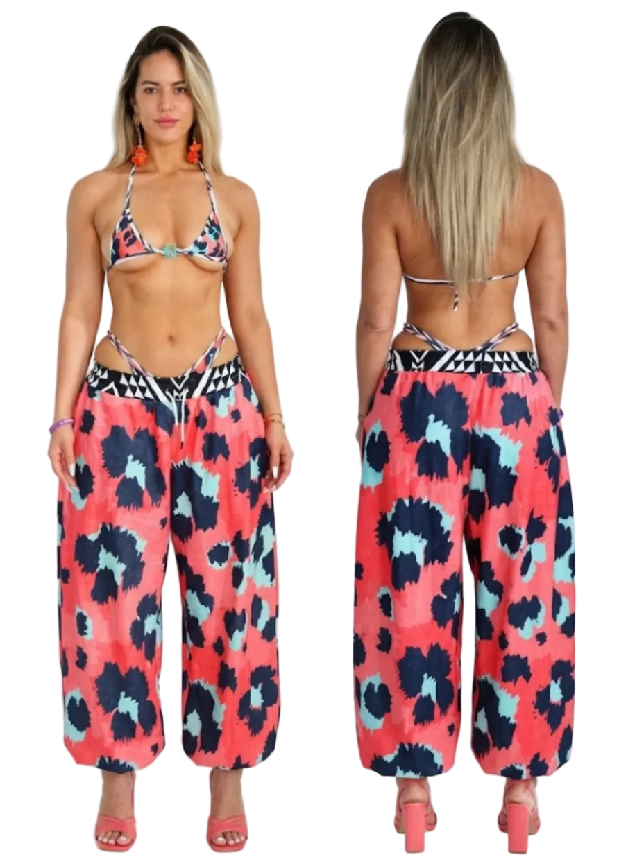 A model is shown from the front and back wearing a two-piece bikini top and matching wide-leg harem pants with a coral pink, navy blue, and light blue abstract pattern.