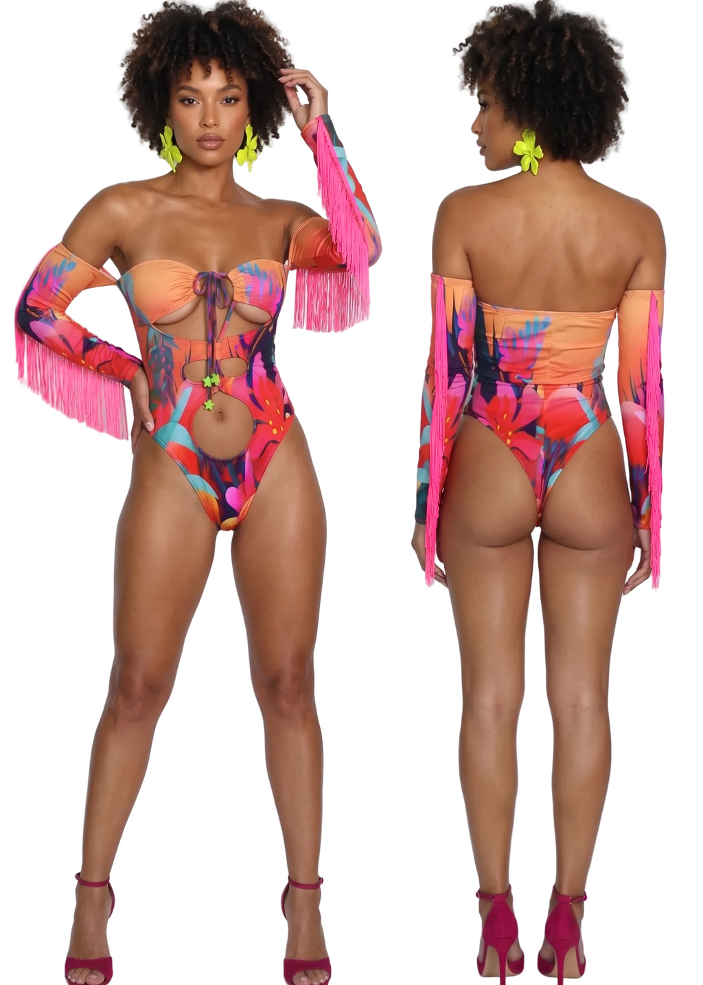 A model is shown from the front and back wearing a vibrant, multicolored floral print one-piece swimsuit with bright pink fringe sleeves and matching pink high heels, set against a plain light gray studio background.